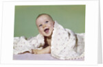 1960s smiling happy baby peeking out from under a blanket by Anonymous