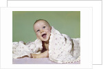1960s smiling happy baby peeking out from under a blanket by Anonymous