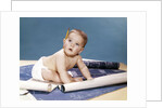 1960s baby architect sitting among blueprints by Anonymous