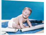 1960s baby eyes closed funny facial expression crawling on rolling out blueprints by Anonymous