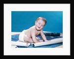 1960s baby eyes closed funny facial expression crawling on rolling out blueprints by Anonymous