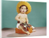 1960s baby wearing cowboy hat and holster with guns pistols looking at camera by Anonymous
