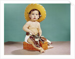 1960s baby wearing cowboy hat and holster with guns pistols looking at camera by Anonymous
