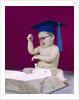 1960s graduate baby wearing mortarboard eyeglasses reading book by Anonymous