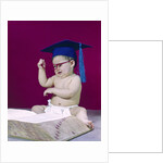 1960s graduate baby wearing mortarboard eyeglasses reading book by Anonymous