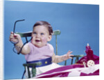1960s smiling baby holding eyeglasses by Anonymous