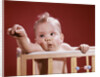 1960s baby reaching out from crib by Anonymous
