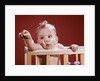 1960s baby reaching out from crib by Anonymous