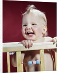 1960s laughing blond baby in crib or playpen by Anonymous