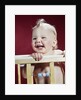 1960s laughing blond baby in crib or playpen by Anonymous