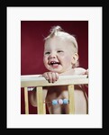 1960s laughing blond baby in crib or playpen by Anonymous