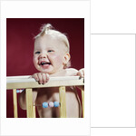 1960s laughing blond baby in crib or playpen by Anonymous