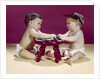 1960s two babies sitting at red stool playing cards poker with gambling chips by Anonymous