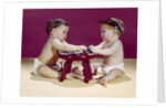 1960s two babies sitting at red stool playing cards poker with gambling chips by Anonymous