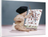 1960s baby artist wearing black beret sitting in front of easel painting by Anonymous