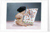 1960s baby artist wearing black beret sitting in front of easel painting by Anonymous