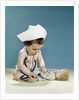 1960s baby wearing nurse nurse's cap stethoscope listening to doll heartbeat chest by Anonymous