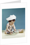 1960s baby wearing nurse nurse's cap stethoscope listening to doll heartbeat chest by Anonymous