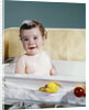 1960s smiling baby in bath looking at camera by Anonymous
