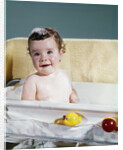 1960s smiling baby in bath looking at camera by Anonymous
