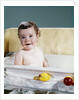 1960s smiling baby in bath looking at camera by Anonymous