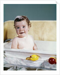1960s smiling baby in bath looking at camera by Anonymous