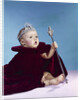 1960s baby dressed as royal queen in a velvet robe cloak cape rhinestone tiara crown and scepter wand by Anonymous