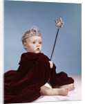 1960s baby girl wearing rhinestone tiara and red velvet cloak holding scepter by Anonymous