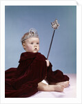 1960s baby girl wearing rhinestone tiara and red velvet cloak holding scepter by Anonymous