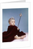 1960s baby girl wearing rhinestone tiara and red velvet cloak holding scepter by Anonymous
