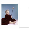 1960s baby girl wearing rhinestone tiara and red velvet cloak holding scepter by Anonymous
