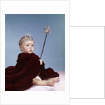 1960s baby girl wearing rhinestone tiara and red velvet cloak holding scepter by Anonymous