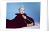 1960s baby dressed as royal queen in red velvet robe cloak cape rhinestone tiara crown and scepter wand by Anonymous