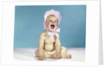 1960s baby wearing pink checked bonnet laughing by Anonymous