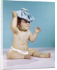 1960s baby sitting with ice pack on top of head by Anonymous