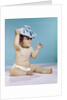 1960s baby sitting with ice pack on top of head by Anonymous