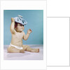 1960s baby sitting with ice pack on top of head by Anonymous