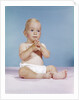 1960s baby wearing cloth diaper sitting with hands together thoughtful pose expression by Anonymous