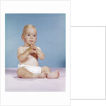 1960s baby wearing cloth diaper sitting with hands together thoughtful pose expression by Anonymous