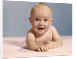 1970s smiling happy baby crawling straight ahead on pink blanket looking at camera by Anonymous