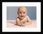 1970s smiling happy baby crawling straight ahead on pink blanket looking at camera by Anonymous