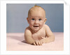 1970s smiling happy baby crawling straight ahead on pink blanket looking at camera by Anonymous