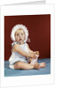 1960s baby girl ruffled bonnet holding bottle funny facial expression looking at camera by Anonymous