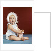 1960s baby girl ruffled bonnet holding bottle funny facial expression looking at camera by Anonymous