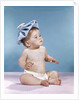 1960s baby sitting with ice pack on top of head by Anonymous