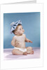 1960s baby sitting with ice pack on top of head by Anonymous