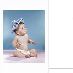 1960s baby sitting with ice pack on top of head by Anonymous