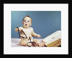 1960s baby holding eyeglasses with open dictionary and magnifying glass research by Anonymous