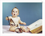 1960s baby holding eyeglasses with open dictionary and magnifying glass research by Anonymous