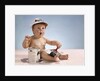 1960s baby with funny facial expression wearing painters cap holding paintbrush sitting by paint can by Anonymous